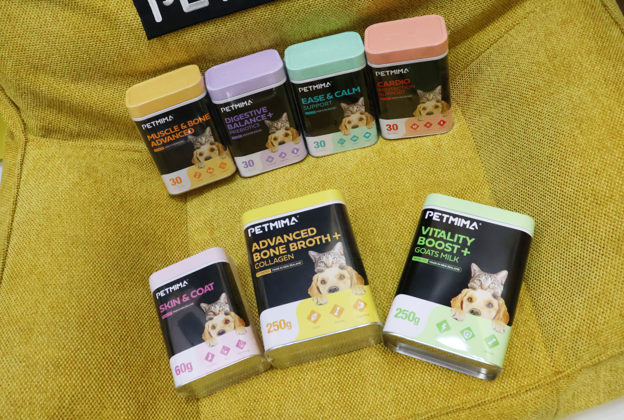 Petmima dog and cat supplement range displayed on a yellow chair